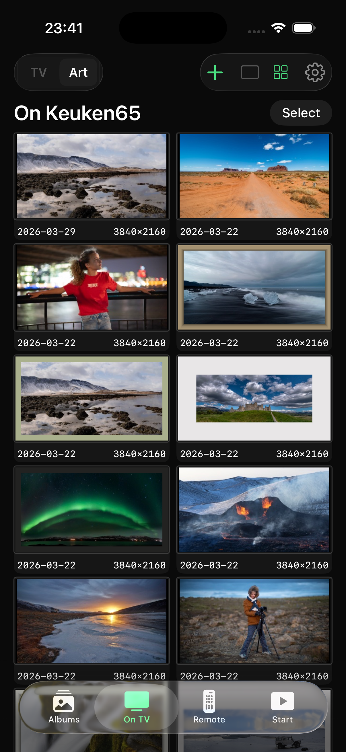 Frame Photos app showing photos being uploaded to a Samsung Frame TV on the wall