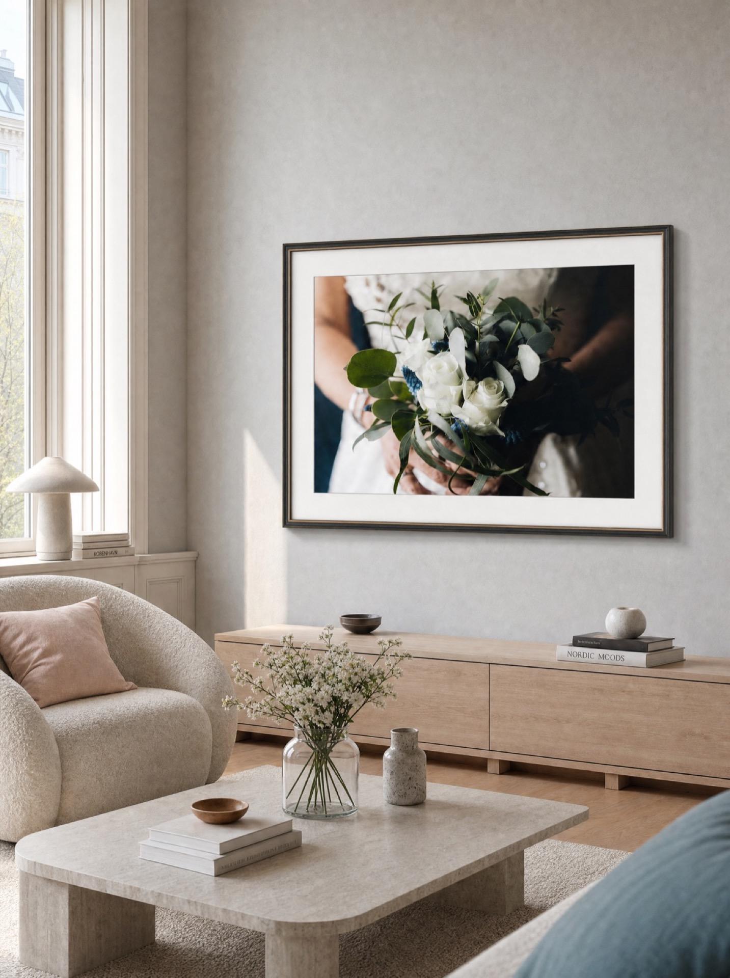 A Samsung The Frame TV showing a bridal bouquet photo in a light Nordic interior